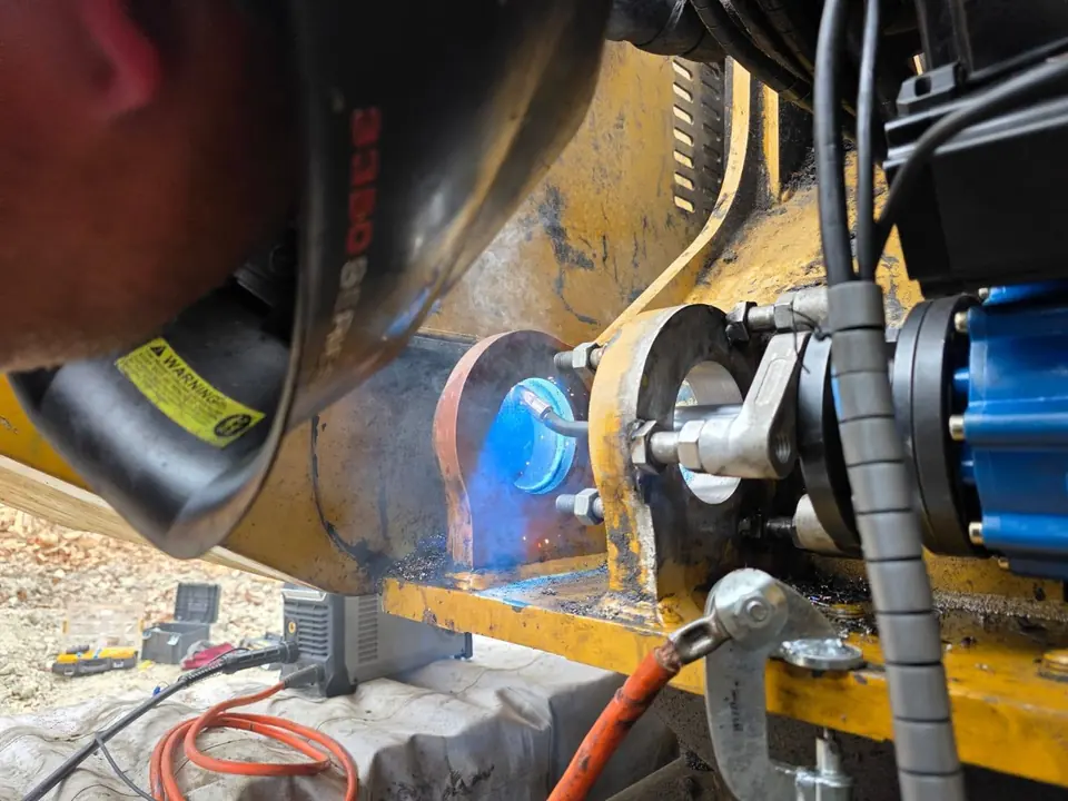 Arc light and leads at a repair being carried out underneath a machine