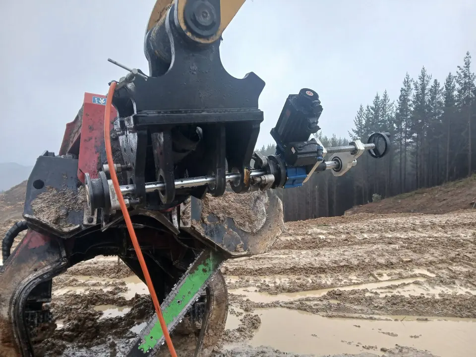 Line boring bar set up through the pin bores of a grapple head onsite