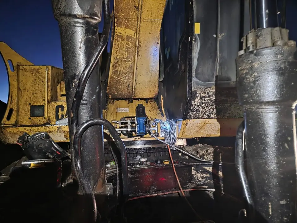 Line boring bar set vertically through a boom casting
