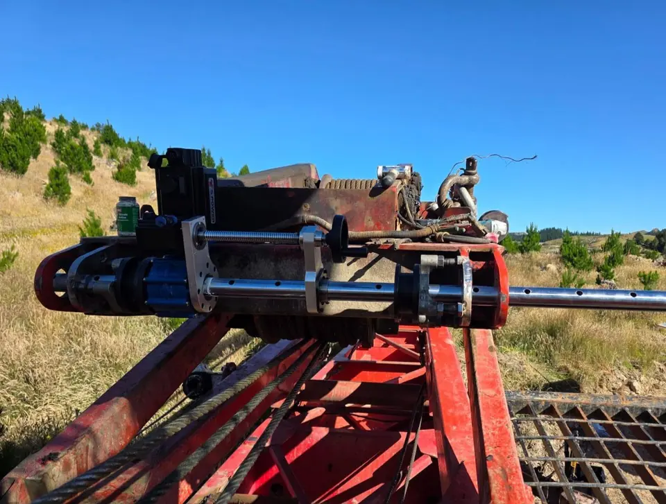Line boring rig mounted along a machine boom out in open country