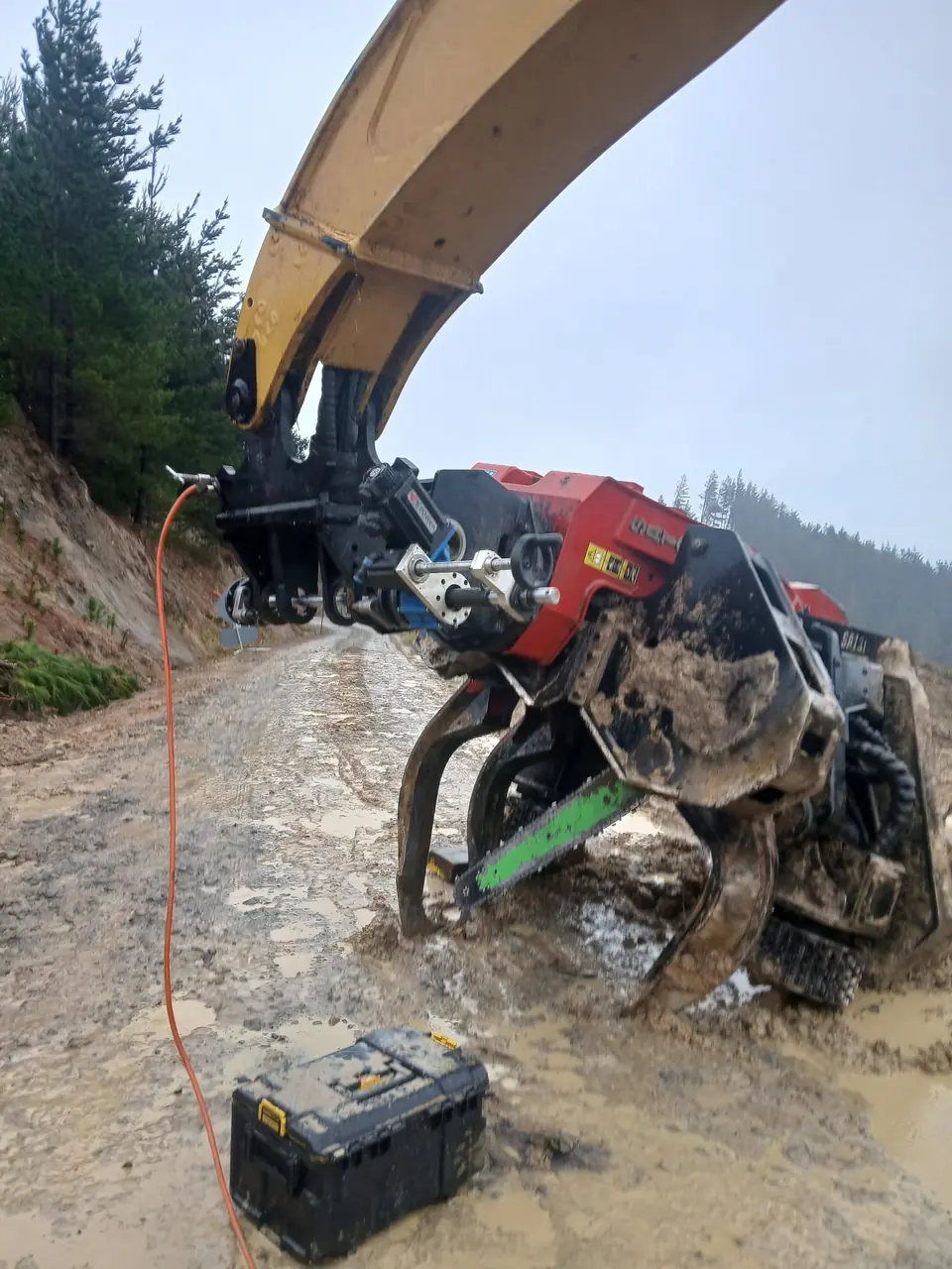 Line boring gear set up at the boom of a forestry machine on a cutover