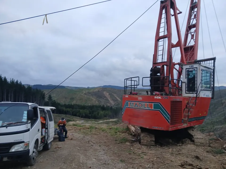 Forestry hauler set up on a skid site with a service vehicle alongside