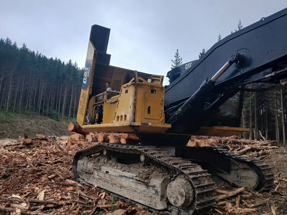 Tracked machine standing with its boom removed for repair work