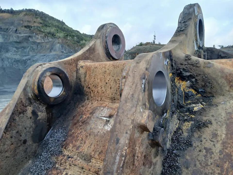 Bucket linkage stripped down at a quarry ready for repair