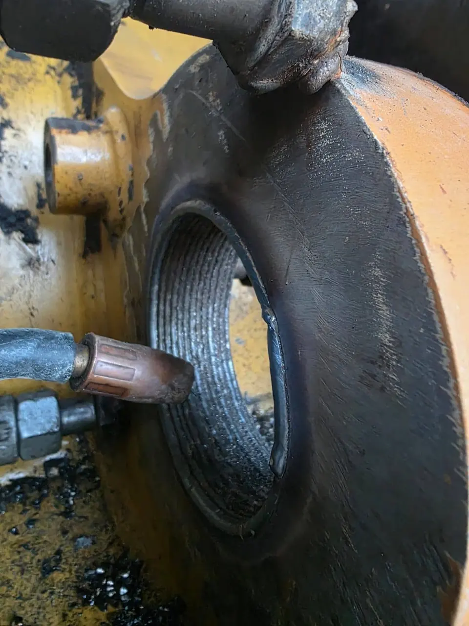 Weld buildup laid in a tight spiral around a worn lug bore